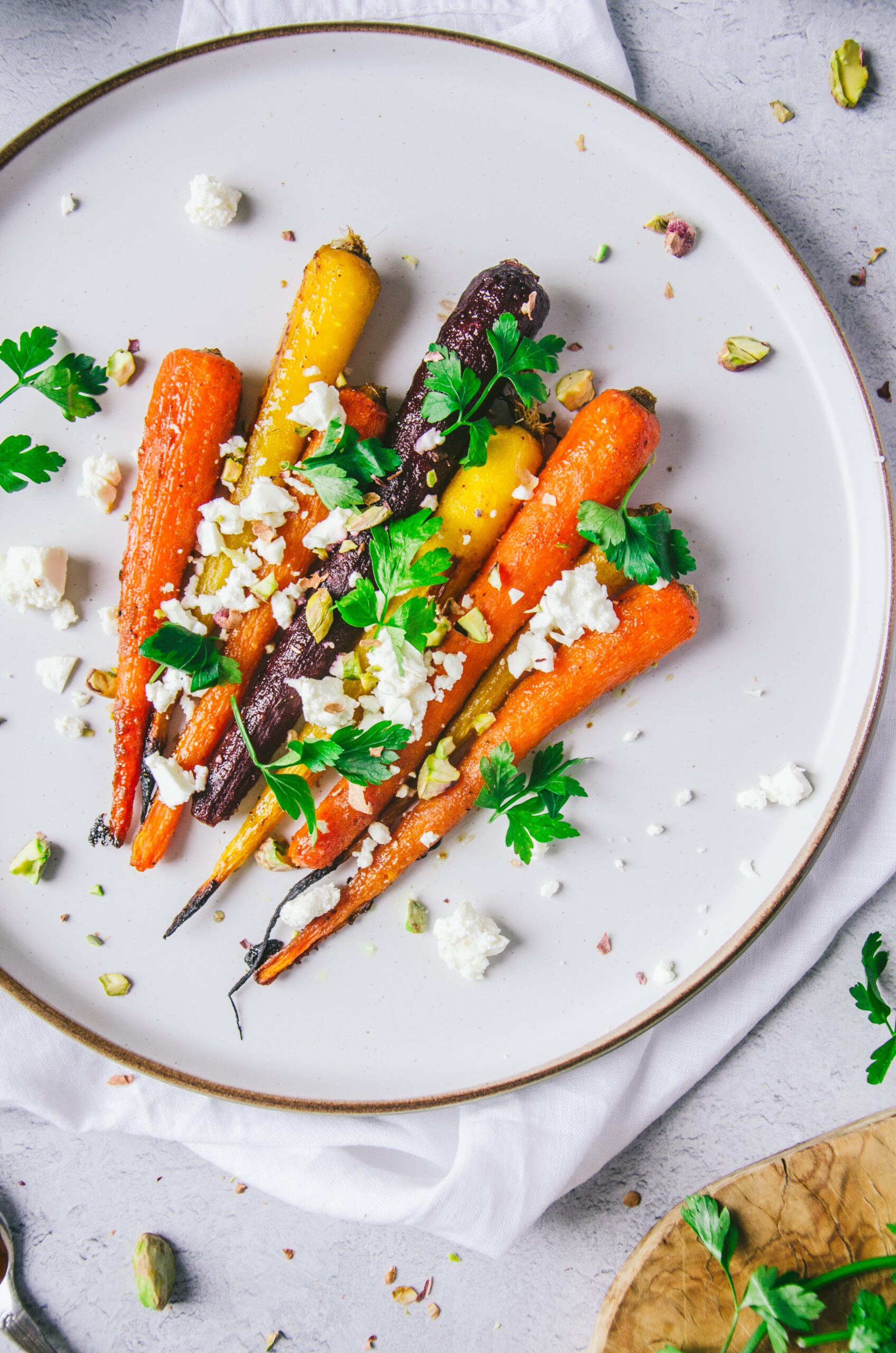yellow orange roasted carrots with green herbs