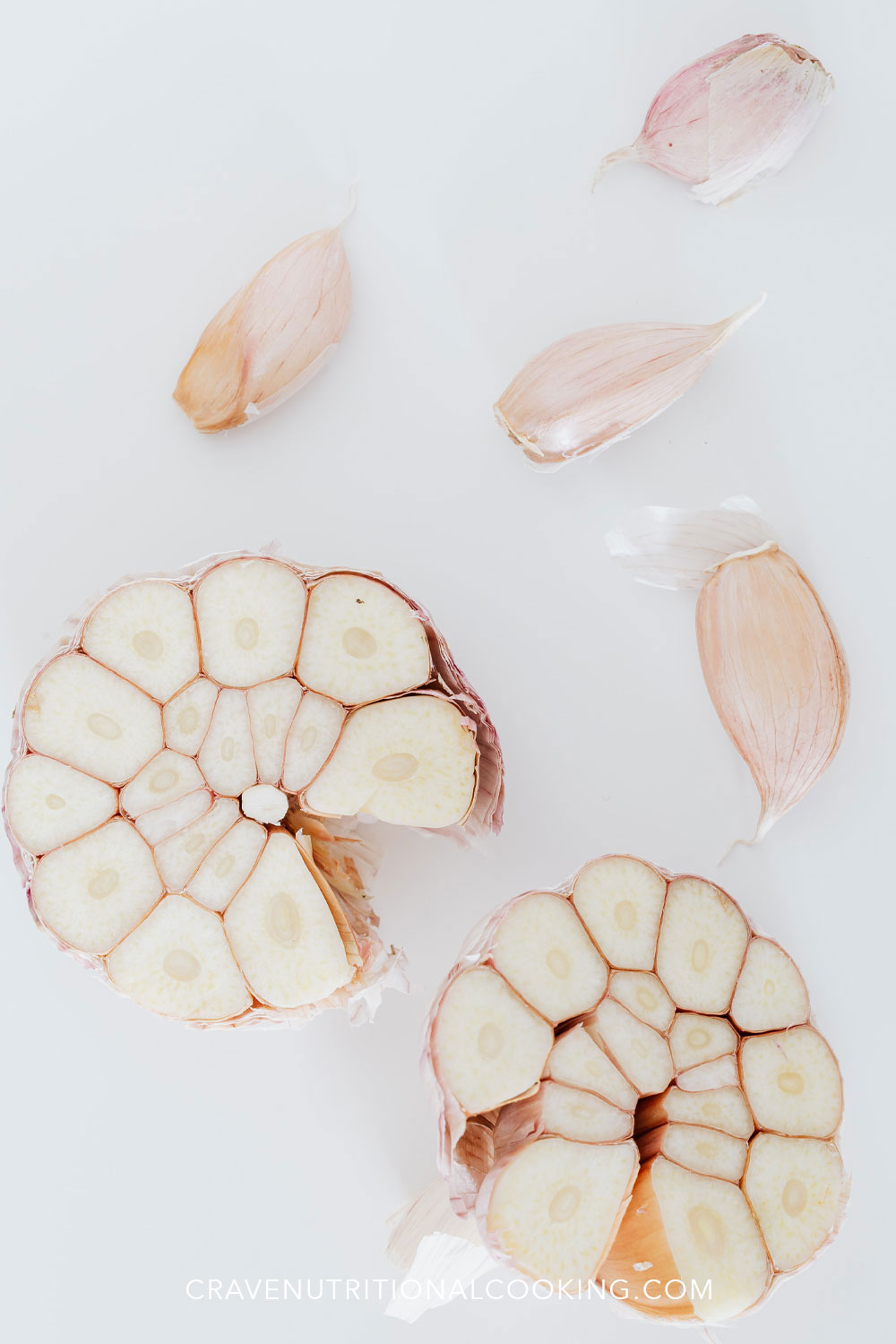 split open garlic cloves showing benefits of garlic