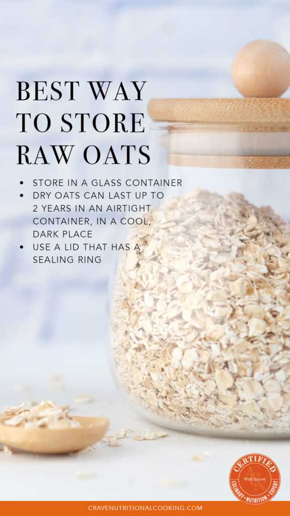 oats recipes - oats in a glass storage jar with a wooden spoon next to it holding a few oats on a white surface