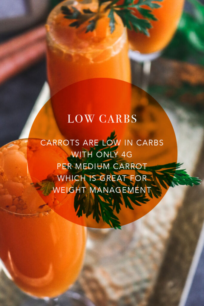 carrots low in carbs for weight loss; weight-loss snack; aerial view of two tall cocktail glasses filled with bright orange carrot juice with celery leaf stalks sticking out from the top, glasses resting on tray