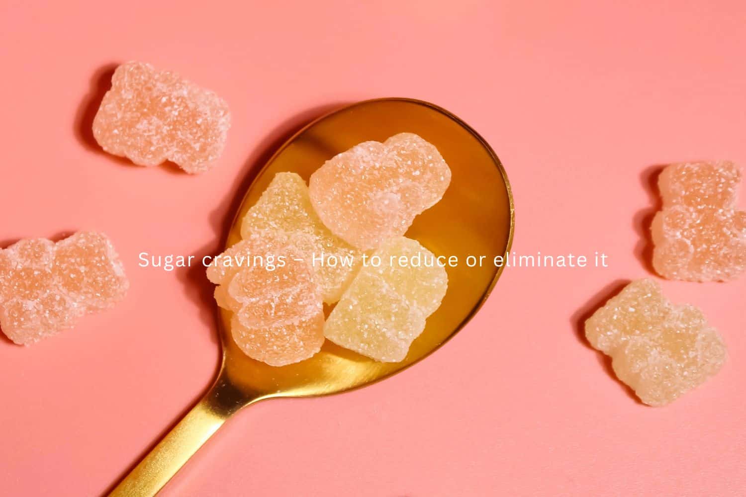 pink background with gold dessert spoon holding 4 sugary gummies and more arranged loosely around it