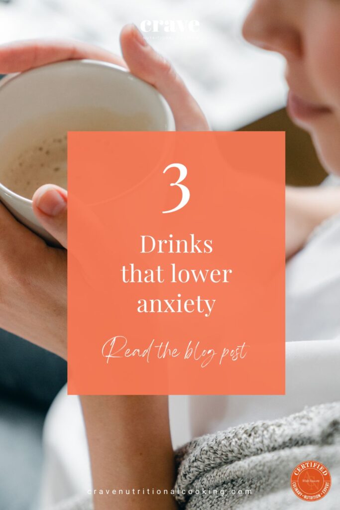 white female holding a white cup filled with a nutritious healing frothy drink; headline in peach, orange block with white print reading '3 drinks that lower anxiety'